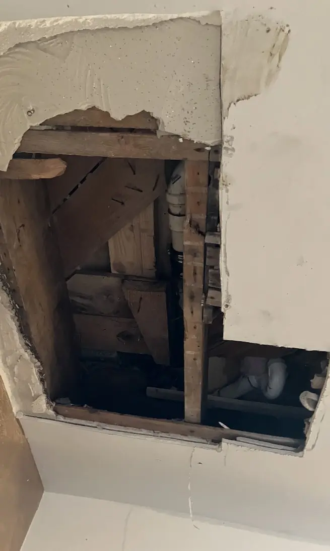 Leaking Tub Drain Repaired From Below — Drain Master NJ Ceiling opened below a bathroom to repair a leaking tub drain line at a New Jersey home