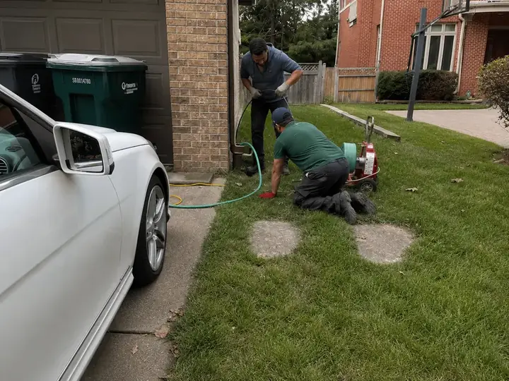 Downspout Drain Line Cleaning — Drain Master NJ Drain Master NJ technicians clearing a buried downspout drain line with a drum machine at a New Jersey home
