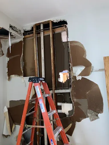 Tying New Drains Into an Existing Stack — Drain Master NJ Wall opened to access an existing drain stack for a new line connection at a New Jersey home