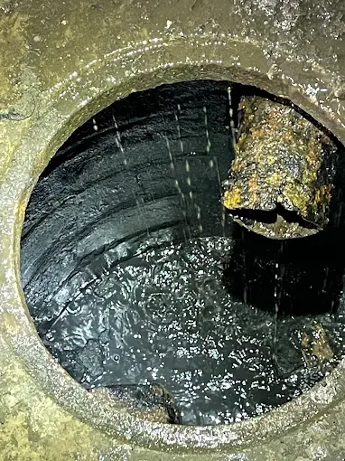 Inside of a commercial grease trap showing heavy grease accumulation before cleaning at a New Jersey restaurant