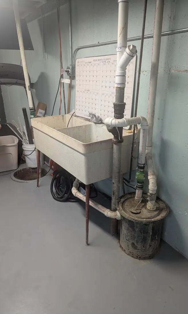 Laundry Sink and Ejector Service — Drain Master NJ Basement laundry utility sink with adjacent ejector basin serviced by Drain Master NJ in New Jersey