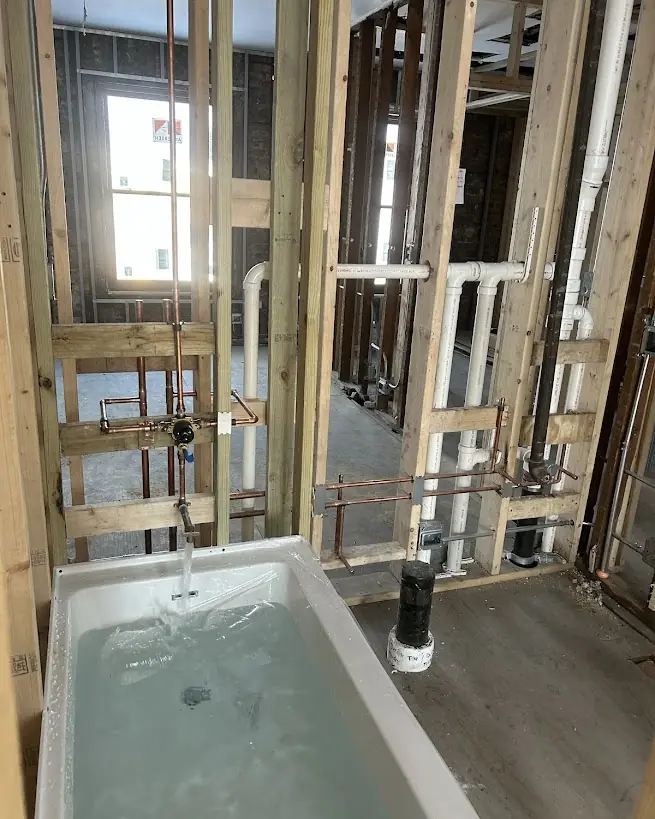 Bathroom Rough-In With Fill Test — Drain Master NJ New bathroom drain and supply rough-in with the tub filled for a flow test at a New Jersey renovation