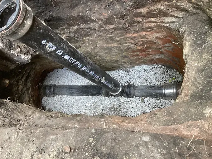 Sewer Line Spot Repair in New Jersey — Drain Master NJ New cast iron sewer pipe installed on fresh gravel bedding during a spot repair by Drain Master NJ in New Jersey