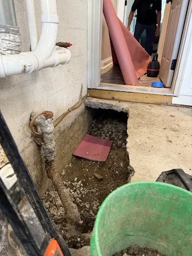 Under-Slab Drain Repair in New Jersey — Drain Master NJ Precise interior excavation exposing an under-slab drain line for repair at a New Jersey home by Drain Master NJ